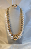 gold-plated layered necklace with white pearls and a matching set of earrings