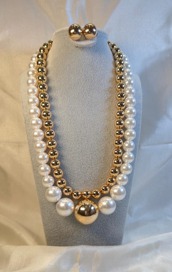 gold-plated layered necklace with white pearls and a matching set of earrings