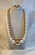 gold-plated layered necklace with white pearls and a matching set of earrings